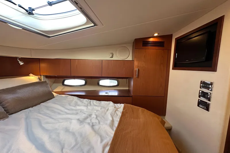 Slide: The Image of Luxurious cabin interior of 2012 Sea Ray 470 Sundancer yacht with bed and TV. - 22
