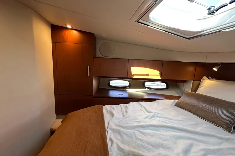 Slide: The Image of Luxurious cabin interior of 2012 Sea Ray 470 Sundancer yacht with skylight and wooden cabinetry. - 23