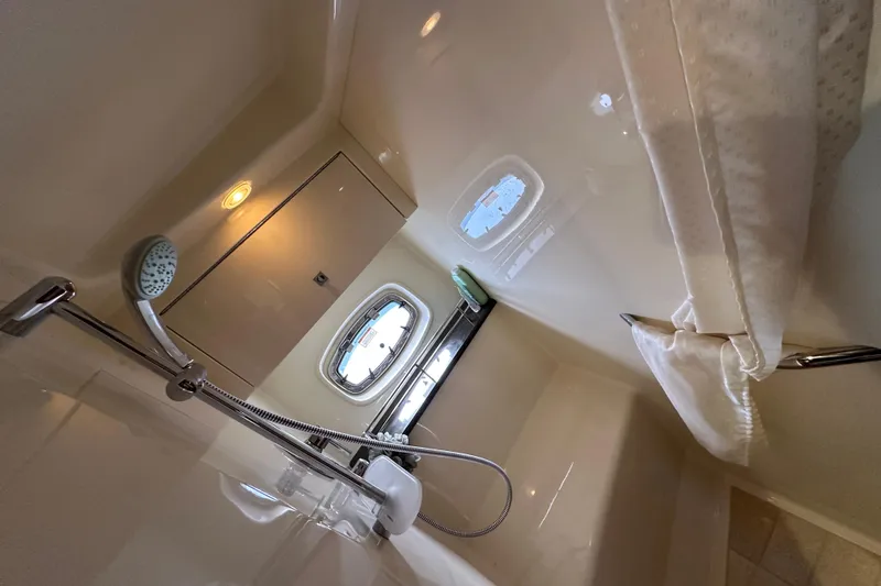 Slide: The Image of Interior of 2012 Sea Ray 470 Sundancer yacht bathroom with shower and porthole window. - 25