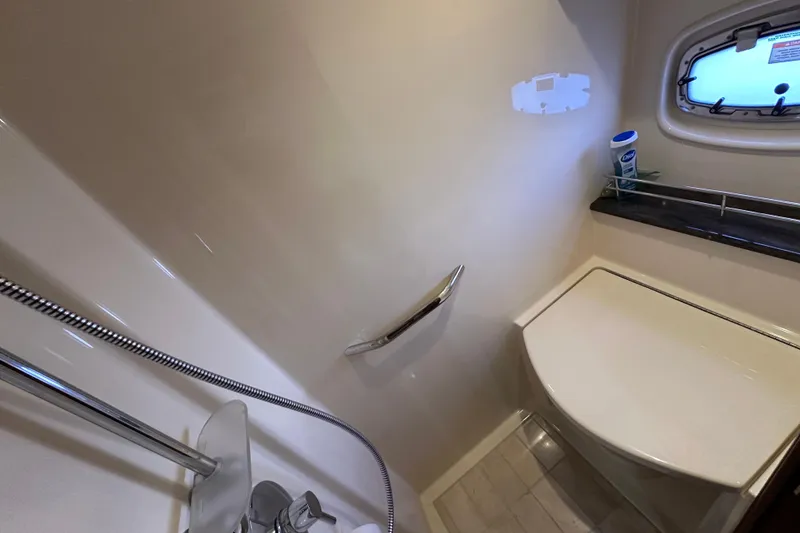 Slide: The Image of Bathroom interior of 2012 Sea Ray 470 Sundancer yacht, featuring shower and window. - 31