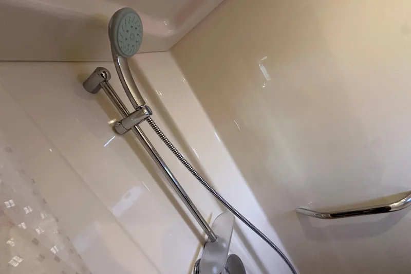 Slide: The Image of Shower area in 2012 Sea Ray 470 Sundancer yacht, featuring modern fixtures and handheld showerhead. - 32