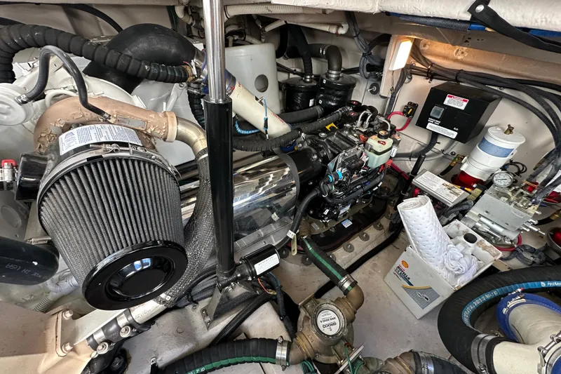 Slide: The Image of Engine room of 2012 Sea Ray 470 Sundancer, showcasing mechanical components and systems. - 34