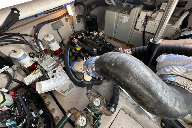 Slide: The Image of Engine room of 2012 Sea Ray 470 Sundancer, showcasing mechanical components and wiring. - 35