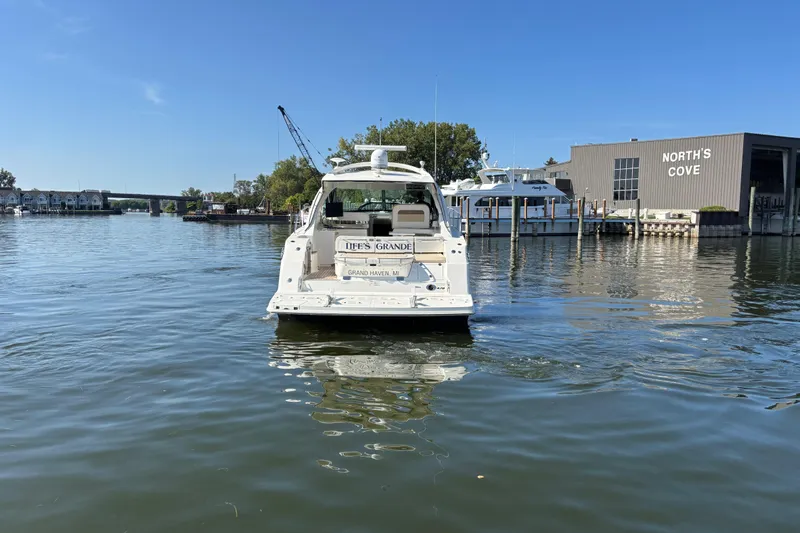 Slide: The Image of 2012 Sea Ray 470 Sundancer yacht on calm water near North's Cove marina. - 4