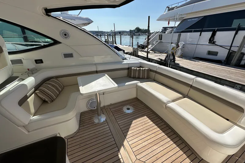 Slide: The Image of Luxurious seating area on a 2012 Sea Ray 470 Sundancer yacht, docked at a marina. - 7