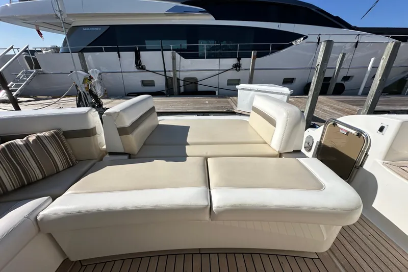 Slide: The Image of Luxurious seating on 2012 Sea Ray 470 Sundancer yacht, docked beside another vessel. - 8