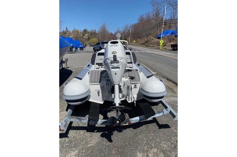 Slide: The Image of 2023 Highfield Sport 330 inflatable boat on trailer, parked roadside. - 12