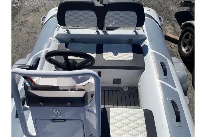 Slide: The Image of 2023 Highfield Sport 330 boat interior with steering wheel and quilted seating. - 13