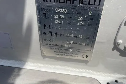 Slide: The Image of Highfield Sport 330 boat specifications plate, 2023 model, showing weight and capacity details. - 15