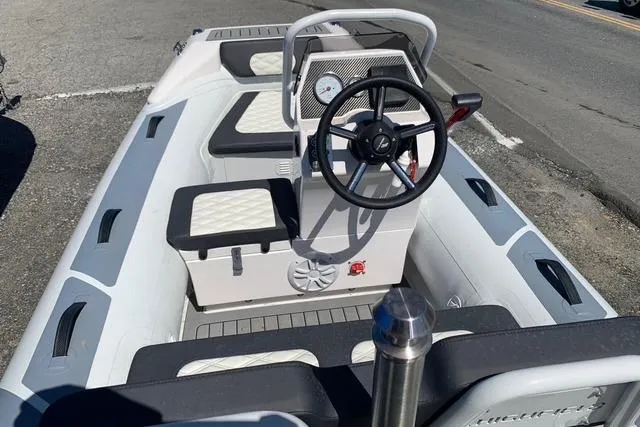 Slide: The Image of 2023 Highfield Sport 330 boat interior with steering wheel and seating. - 5