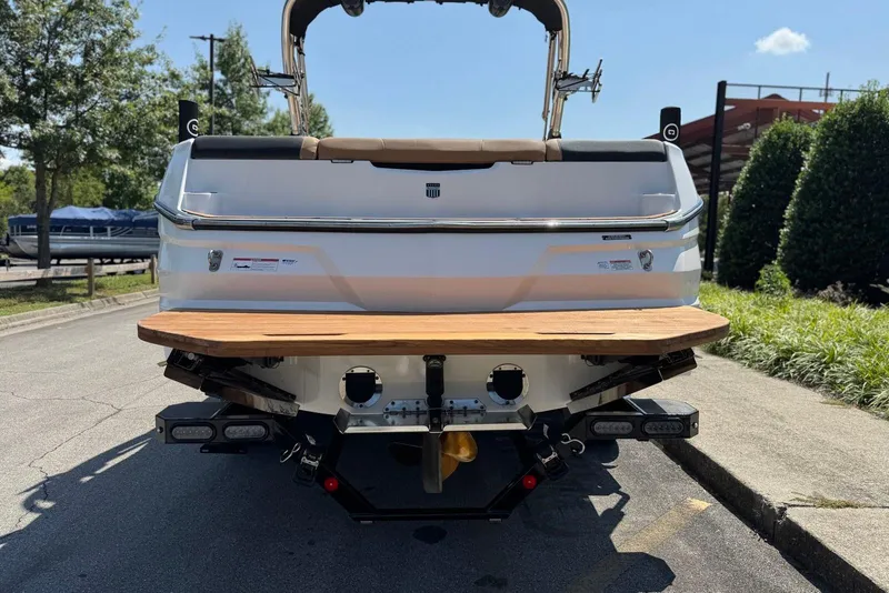 Slide: The Image of Rear view of 2021 MasterCraft NXT24 boat with wooden swim platform. - 17