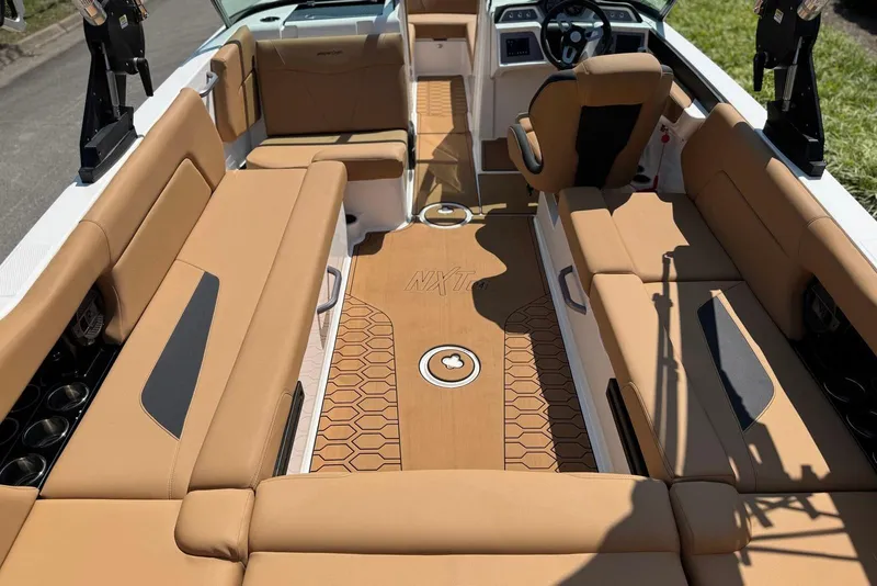 Slide: The Image of 2021 MasterCraft NXT24 boat interior with tan seating and modern dashboard design. - 20