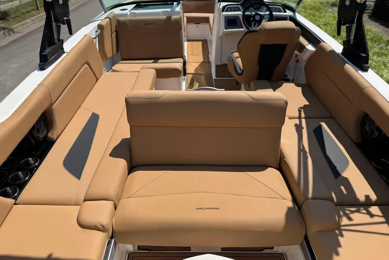 Slide: The Image of 2021 MasterCraft NXT24 boat interior with tan leather seating and modern dashboard. - 22