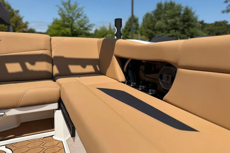Slide: The Image of 2021 MasterCraft NXT24 boat interior with tan seating and speaker system. - 26