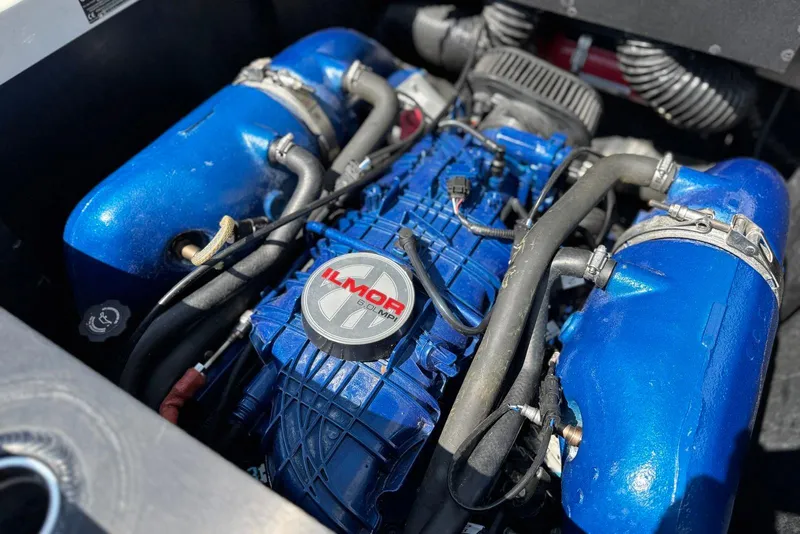 Slide: The Image of 2021 MasterCraft NXT24 engine with blue Ilmor components and visible hoses. - 28