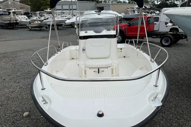 Slide: The Image of 2007 Boston Whaler 200 Dauntless boat displayed in a marina setting. - 1