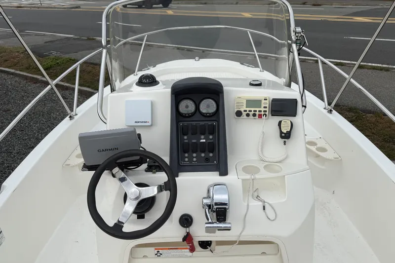 Slide: The Image of 2007 Boston Whaler 200 Dauntless boat dashboard with Garmin navigation system and controls. - 3