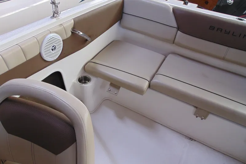 Slide: The Image of 2015 Bayliner 180 Bowrider interior with beige seating and speaker. - 12