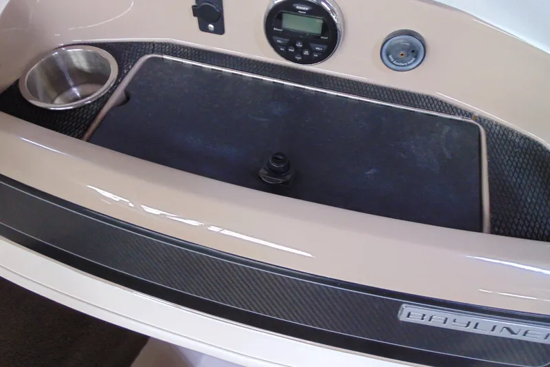 Slide: The Image of 2015 Bayliner 180 Bowrider dashboard with cup holder and control panel. - 13