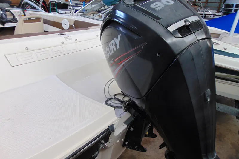 Slide: The Image of 2015 Bayliner 180 Bowrider with Mercury 90 outboard engine in showroom. - 3