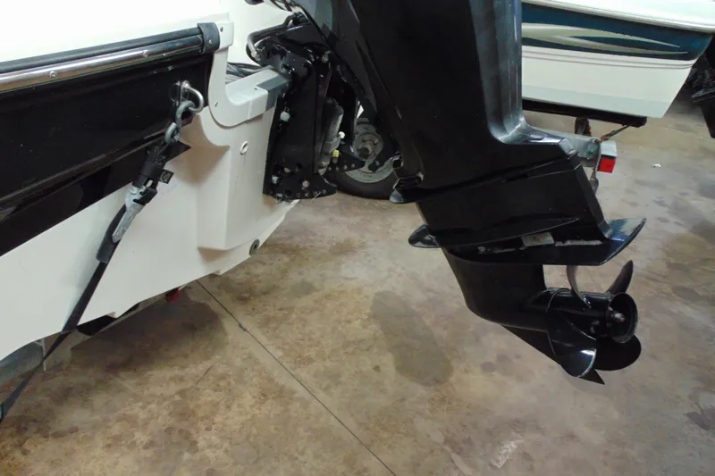 Slide: The Image of 2015 Bayliner 180 Bowrider boat engine and propeller detail in a garage setting. - 4