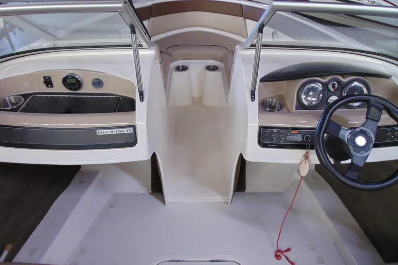 Slide: The Image of 2015 Bayliner 180 Bowrider interior dashboard with steering wheel and instrument panel. - 6