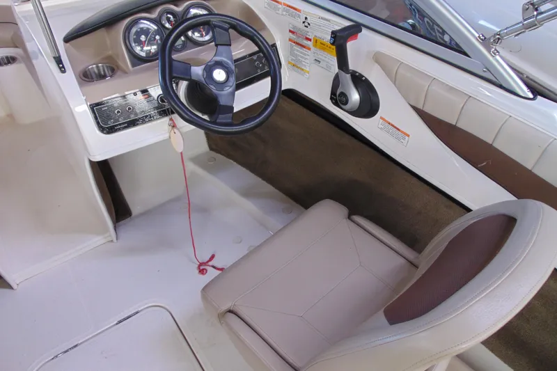 Slide: The Image of 2015 Bayliner 180 Bowrider cockpit with steering wheel and control panel. - 8