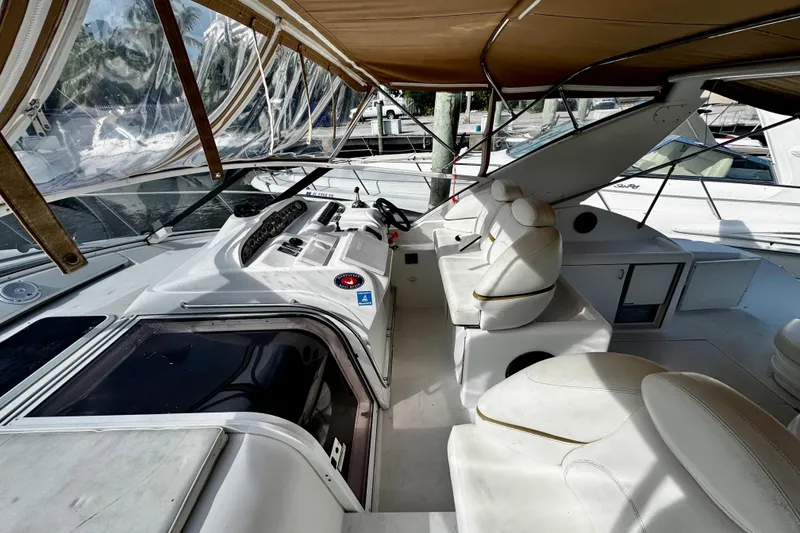 Slide: The Image of 2000 Trojan 440 Express yacht interior with white seating and control panel. - 10