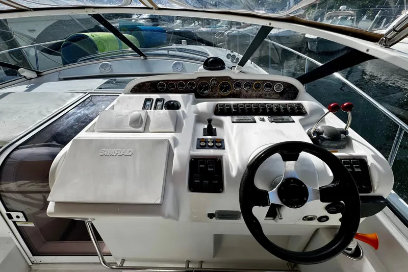 Slide: The Image of Cockpit of 2000 Trojan 440 Express boat with steering wheel and control panel. - 11