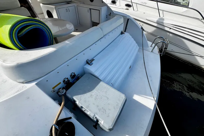 Slide: The Image of Rear deck of a 2000 Trojan 440 Express yacht with storage and seating. - 17