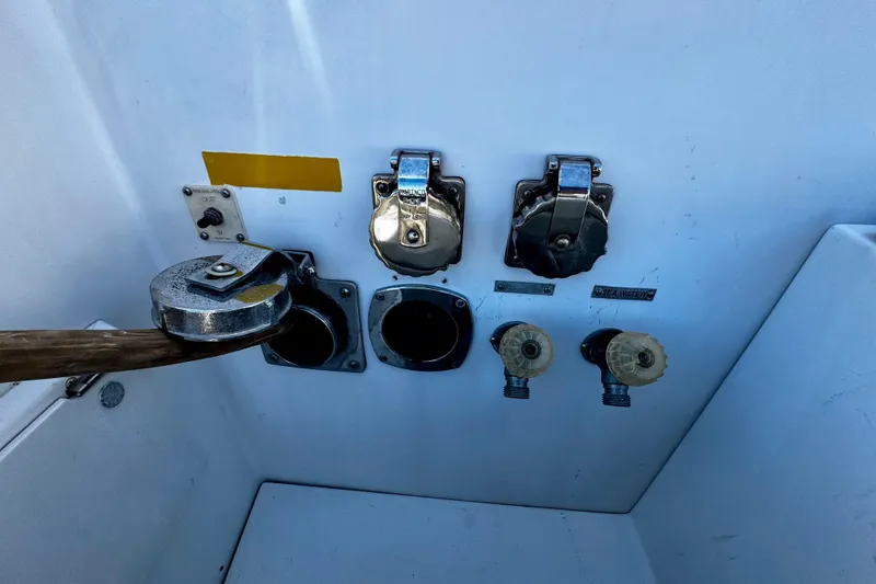 Slide: The Image of Boat utility panel with metal fittings and sea water labels, Trojan 440 Express, 2000 model. - 19