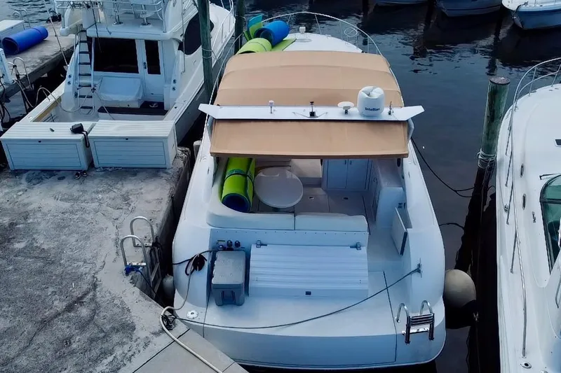 Slide: The Image of 2000 Trojan 440 Express yacht docked at marina, aerial view. - 2