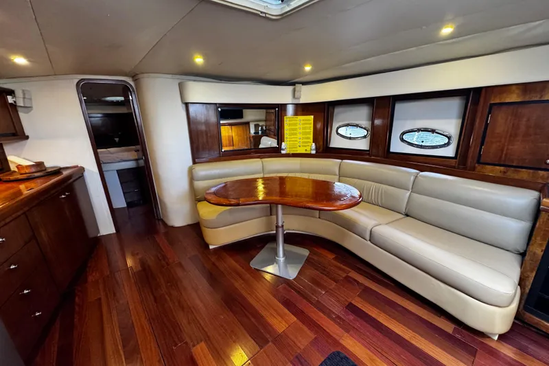 Slide: The Image of Luxurious interior of 2000 Trojan 440 Express yacht with elegant seating and wooden finishes. - 20