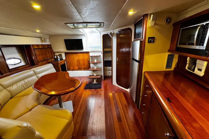 Slide: The Image of Luxurious interior of 2000 Trojan 440 Express yacht with wood finishes and modern amenities. - 23