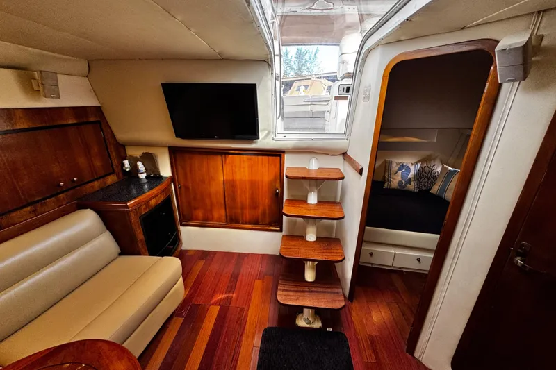 Slide: The Image of Luxurious interior of 2000 Trojan 440 Express yacht with wood accents and modern amenities. - 24