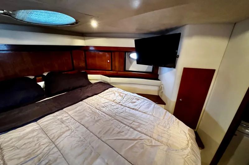 Slide: The Image of Luxurious cabin interior of 2000 Trojan 440 Express yacht with bed and TV. - 28