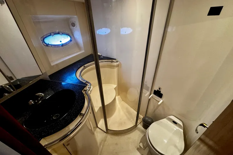 Slide: The Image of Luxurious bathroom in 2000 Trojan 440 Express yacht with shower, sink, and toilet. - 29