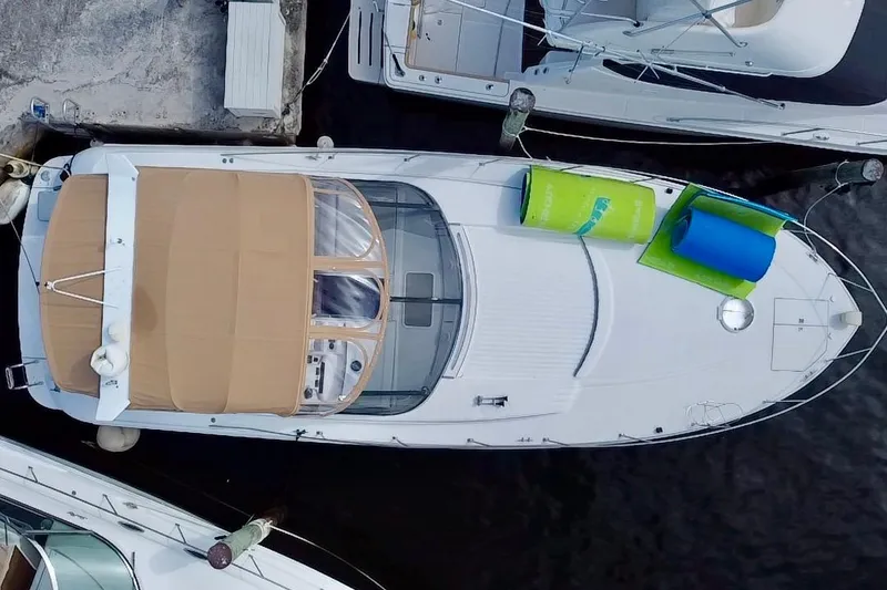 Slide: The Image of Aerial view of a 2000 Trojan 440 Express yacht docked at a marina. - 3