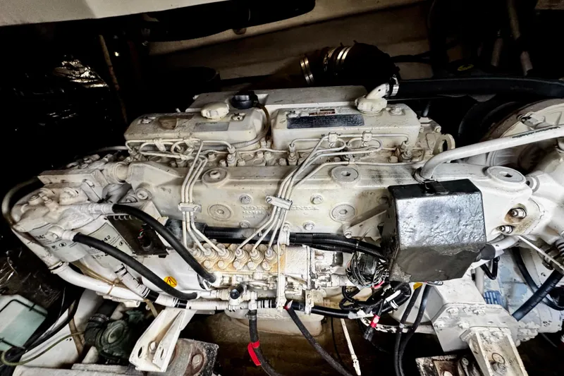 Slide: The Image of Engine of a 2000 Trojan 440 Express boat, showcasing intricate mechanical components. - 32