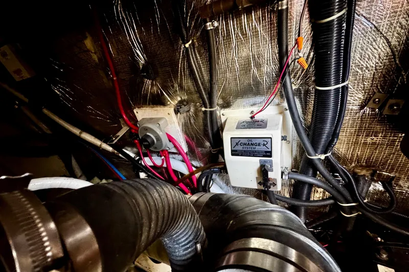 Slide: The Image of Engine room of 2000 Trojan 440 Express with oil exchange system and wiring. - 34