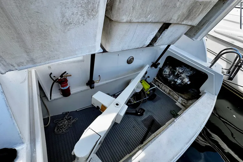 Slide: The Image of Open engine compartment of a 2000 Trojan 440 Express boat with visible equipment and fire extinguisher. - 35