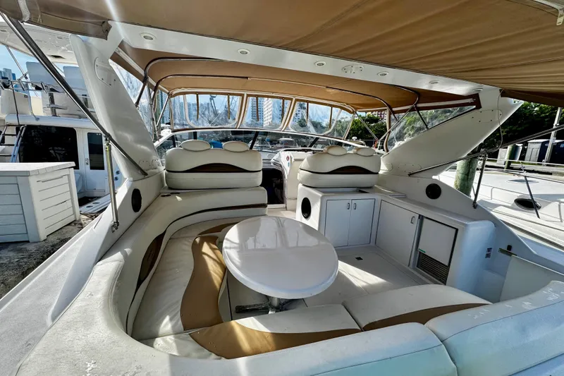 Slide: The Image of Interior view of a 2000 Trojan 440 Express yacht with seating and table. - 4