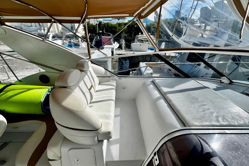 Slide: The Image of Trojan 440 Express 2000 yacht interior with white seating and canopy. - 9