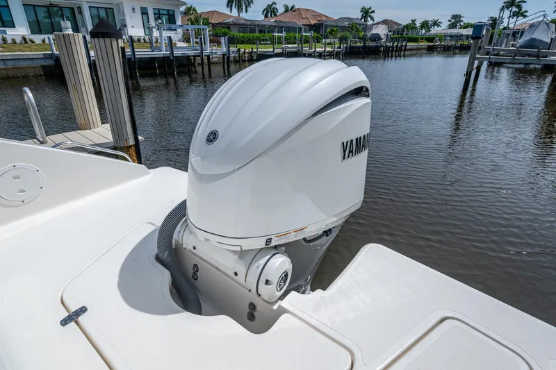 Slide: The Image of 2022 Pursuit DC 246 Dual Console with Yamaha outboard engine by a dock. - 12