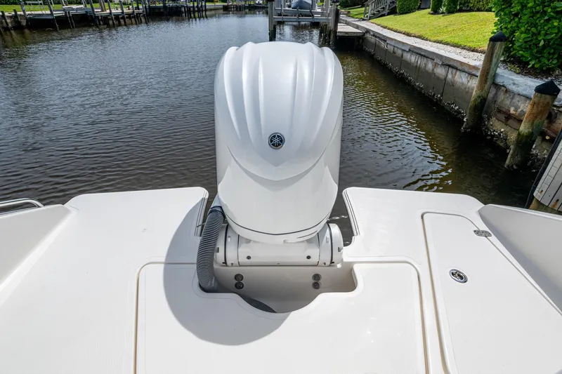Slide: The Image of 2022 Pursuit DC 246 Dual Console boat with outboard motor on calm water. - 13