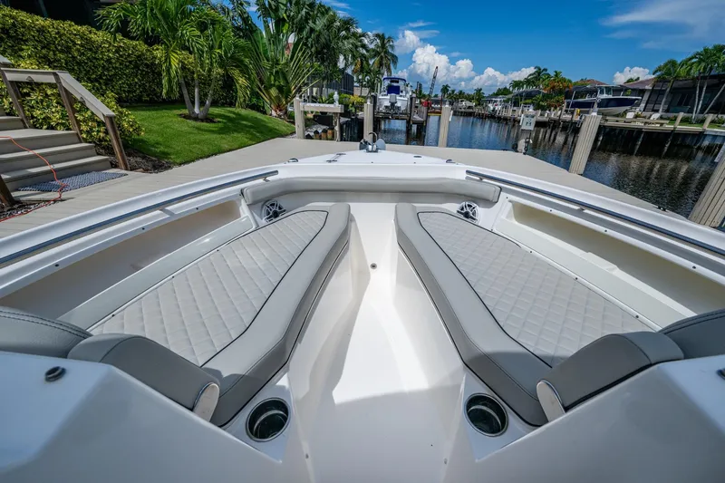 Slide: The Image of 2022 Pursuit DC 246 Dual Console boat interior with luxurious seating and waterfront view. - 28