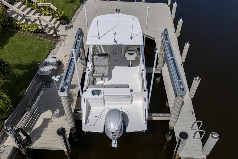 Slide: The Image of 2022 Pursuit DC 246 Dual Console boat docked at marina, aerial view. - 40