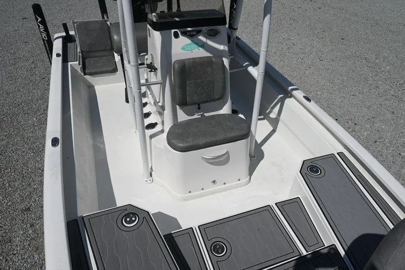 Slide: The Image of 2025 Avid 21 Mag boat interior with gray seating and deck, showcasing modern design. - 10