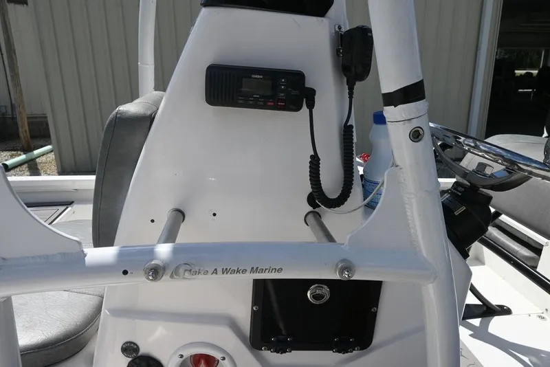 Slide: The Image of Interior of 2025 Avid 21 Mag boat with radio and steering console. - 7