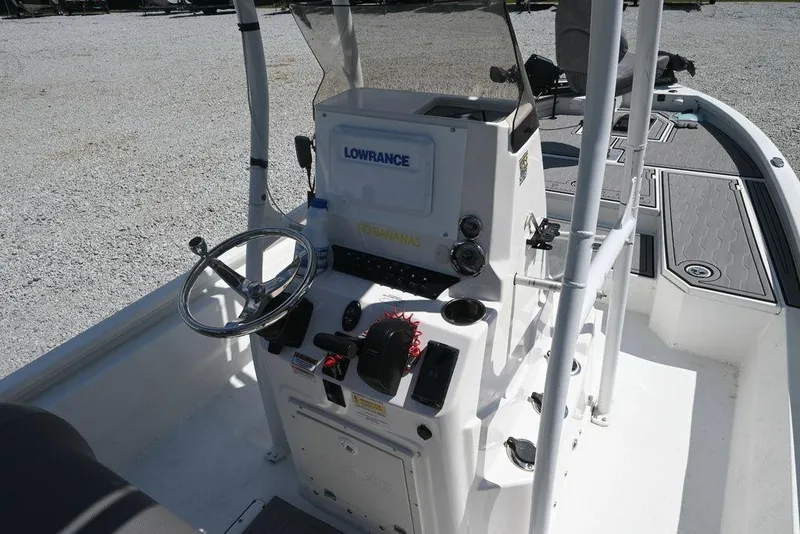 Slide: The Image of Center console of 2025 Avid 21 Mag boat with steering wheel and controls. - 9